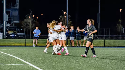 Maine women's soccer celebrates a goal.