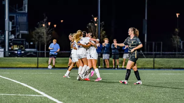 Maine women's soccer celebrates a goal.