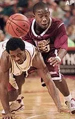 Boston College guard Xavier Singletary, left, and Massachusetts guard Shannon Crooks race for a loose ball during the first half.