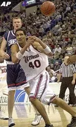 UMass' Micah Brand dishes the ball off to a nearby teammate during first half action.