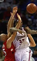 Massachusetts' Kitwana Rhymer tries to pass the ball as he gets tangled with Richmond's Rick Houston during the first half at the Charlotte Coliseum in Charlotte, N.C., Saturday, Dec. 30, 2000 during the Tournament of Champions