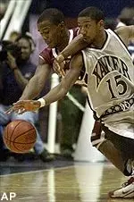 Massachusetts guard Shannon Crooks and Xavier guard Maurice McAfee chase a loose ball in the first half Saturday.