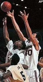 Shannon Crooks and Micah Brand head up for the same rebound during the first half of Tuesday night's loss to George Washington.