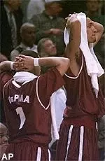 Massachusetts' Jonathan DePina, left, and Micah Brand watch the final seconds of their team's 66-65 loss to Siena Thursday.