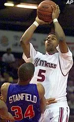 Monty Mack shoots over Duquesne's Charles Stanfield in the first half of the 77-52 UMass win Wednesday.
