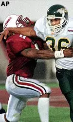 Massachusetts defensive back Lance Overby makes a tackle during a first-half run in the season opener.