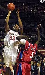 Massachusetts' Kitwana Rhymer shoots over Dayton's Nate Green during their game at the Mullins Center in Amherst, Mass. on Thursday.