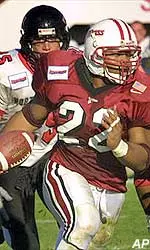 Tailback Omari Howard is pursued by Northeastern defenders during the third quarter. Massachusetts won 17-10