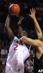 Massachusetts' Jackie Rogers (2) puts up a shot as Temple's Kevin Lyde defends during the first half at the Mullins Center in Amherst, Mass., Saturday.