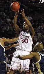 Shannon Crooks shoots over Jaason Smith and Chris Monroe during the first half.