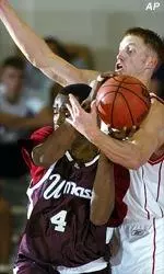 Gabriel Lee gets tied up by Utah's Britton Johnsen in the Minutemen's 69-53 setback in Maui.