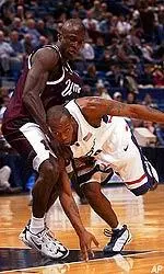 Ryan Swaller tries to prevent UConn's Taliek Brown from getting to the basket in the first half.