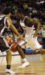 Shannon Crooks dribbles past St. Bonaventure's Robert Cheeks during the first half.