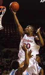Shannon Crooks shoots over Rhode Island's Dinno Daniels, left, and Marcel Momplaisir during the first half, Wednesday.
