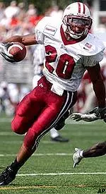 Raunny Rosario makes a turn towards the endzone at the end of the second quarter around Northeastern's Charles Cameron.