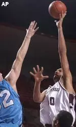 Micah Brand puts up a shot contested by Columbia's Chris Wiedemann during the first half.