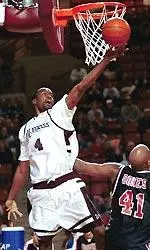 Massachusetts' Gabe Lee (4) shoots over Duquesne's Ron Dokes (41) in the first half.