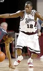 Temple guard Maurice Collins tries to maintain control of the ball while tripping under the pressure of Anthony Anderson during first-half action.