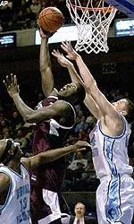 Jackie Rogers goes up over two Rhode Island defenders during the first half.
