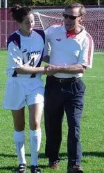 Head Coach Jim Rudy congratulates Elizabeth Weinsten after she set up the winning goal.
