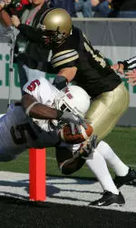 Massachusetts' Steve Baylark (5) falls into the endzone as Army's Dhyan Tarver (20) tries to stop him on Saturday, Nov. 12, 2005, in the second quarter of their game at the United States Military Academy at West Point, N.Y.
