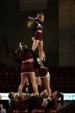 The cheerleading squad performs at a men's basketball game this season.
