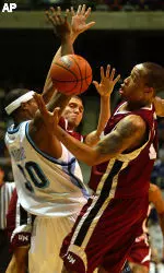 Rashaun Freeman, right, and James Life, rear, strip the ball from Rhode Island's J.R. Moore during a college basketball game. (AP Photo/Joe Giblin)