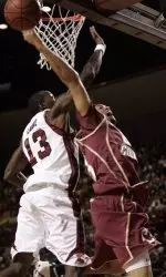 Boston College's Sean Marshall, right, tries to shoot over University of Massachusetts' Stephane Lasme (13) during the first half of college basketball game in Amherst,Mass, Saturday, Dec., 2, 2006. (AP Photo/Chitose Suzuki)