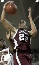 Etienne Brower (22) grabs a rebound in front of Boston College's Corey Raji in the first half. (AP Photo/Michael Dwyer)