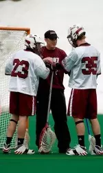 Coon working with goaltenders Doc Schneider (23) and Mike Wilson (35).
