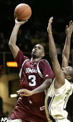 Gary Forbes shoots over the reach of Vanderbilt's Darshawn McClellan in the first half. (AP Photo/Mark Humphrey)