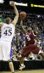 Ricky Harris puts up a shot under pressure from Kansas' Cole Aldrich. Harris scored 18 points leading Massachusetts to a 61-60 win. (AP Photo/Charlie Riedel)