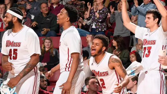 The bench celebrates a Zach Lewis 3-pointer