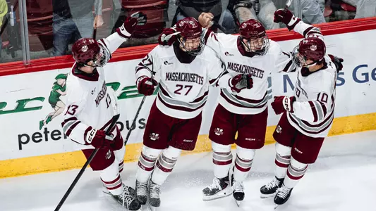 UMass celebrates Melvin Novotny goal along the boards