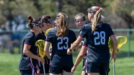 Players huddled on the field at Eastern Michigan