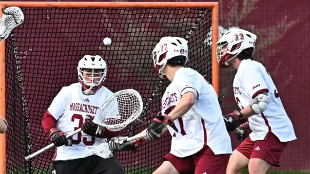 Owen Salanger makes a save, Zach Auble defending in front of the cage