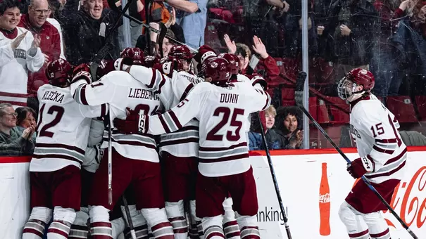 Team celebration on the ice at the Mullins Center following a goal