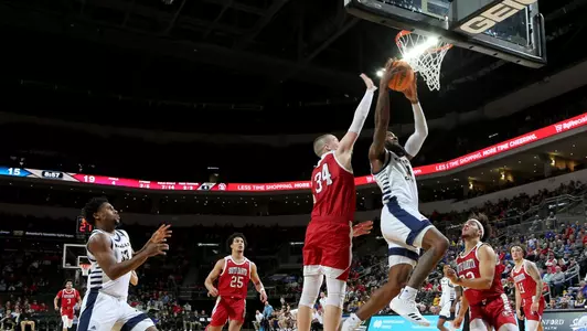 SIOUX FALLS, SD - MARCH 6: Arkel Lamar #3 of the UMKC Kangaroos goes for the dunk as Tasos Kamateros #34 of the South Dakota Coyotes tries for the block during the Summit League Basketball Tournament at the Denny Sanford Premier Center on March 5, 2022 in Sioux Falls, South Dakota. (Photo by Dave Eggen/Inertia)