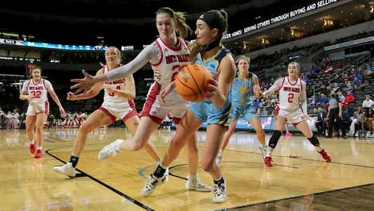 SIOUX FALLS, SD - MARCH 7: Mandy Willems saves the ball from going out of bounds in front of Chloe Lamb #22 of the South Dakota Coyotes at The Summit League Basketball Tournament at the Denny Sanford Premier Center on March 7, 2022 in Sioux Falls, South Dakota. (Photo by Dave Eggen/Inertia)