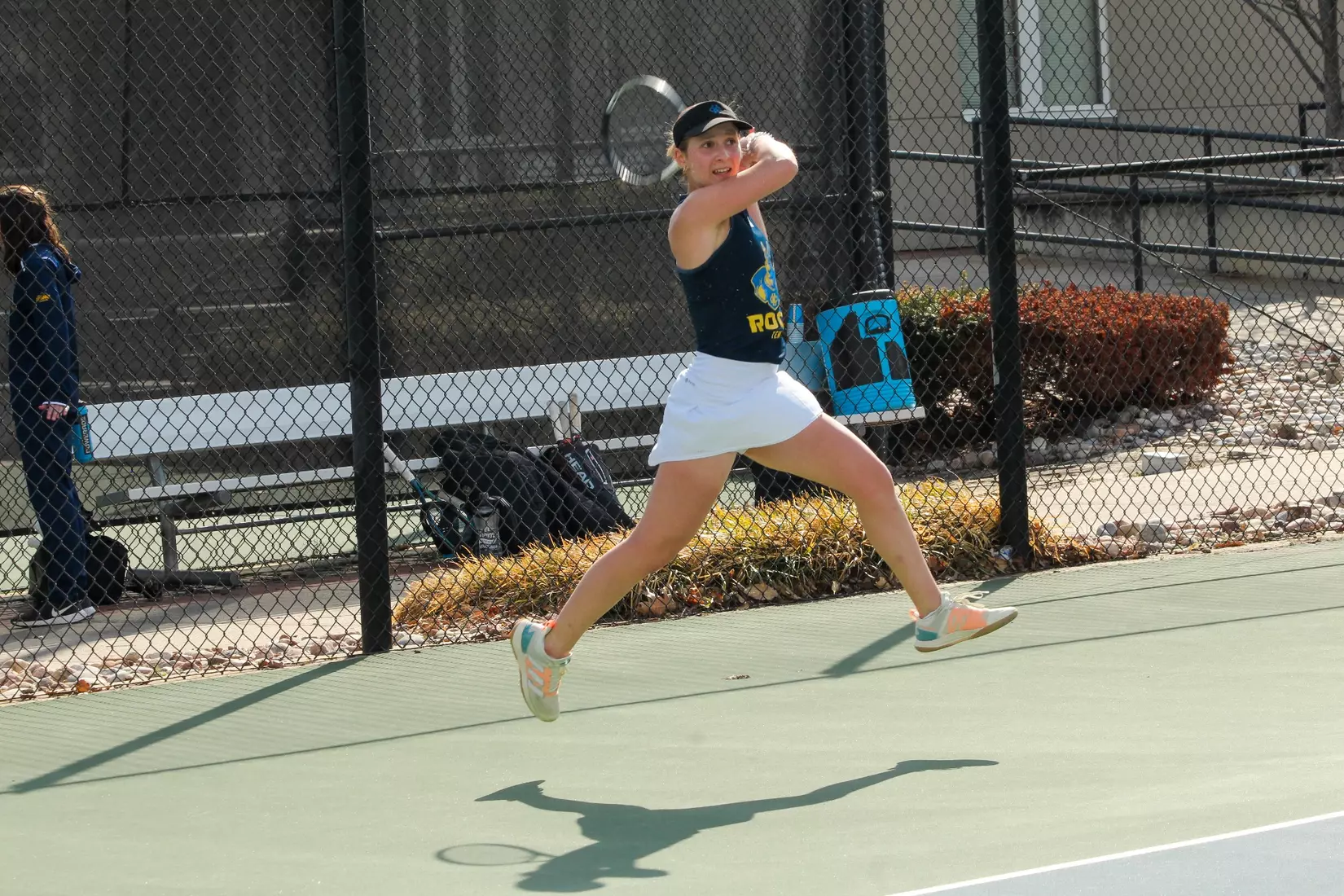 Chrobak jumps and holds the follow through on a forehand during her match against South Dakota.