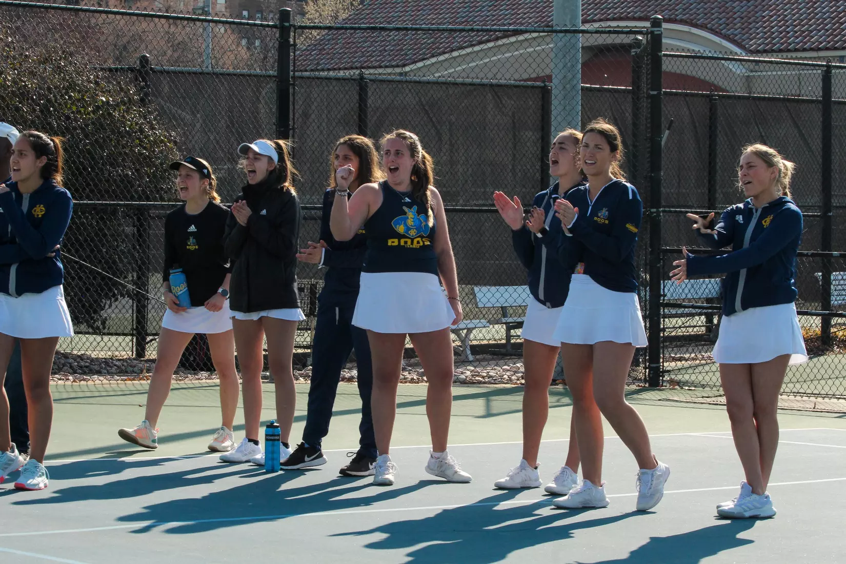 The Roos cheer on Miley during the third set of her decisive victory against South Dakota.