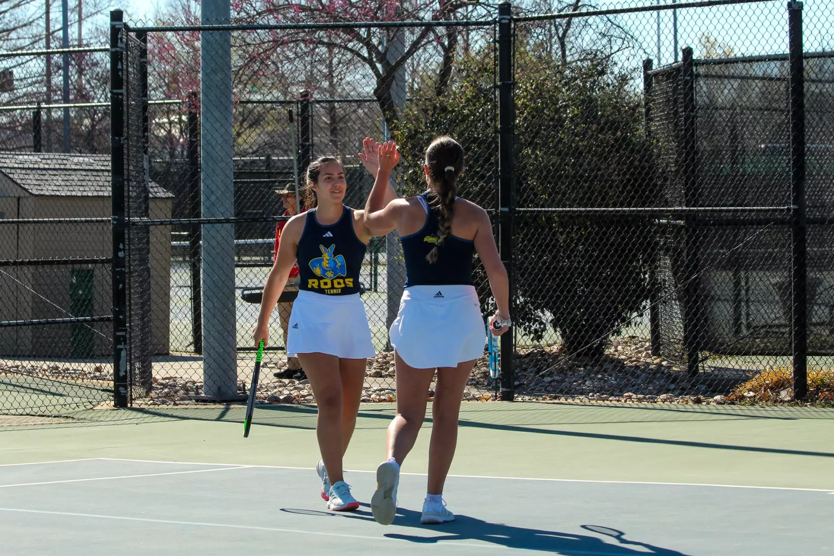 Cardona and Kate Miley high-five after winning a point at No. 2 doubles. The duo won, 6-0.