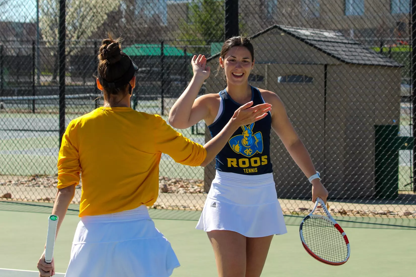 Eva Kresovic gives partner Timofeyeva a high-five after winning a point at No. 3 doubles.
