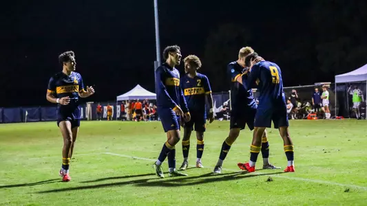 An elated Kansas City side celebrates Elie Kisoka's 87th minute game-winner against Oral Roberts