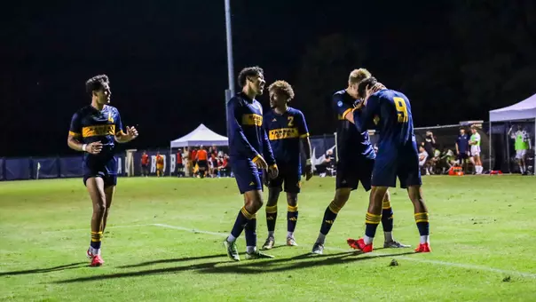 An elated Kansas City side celebrates Elie Kisoka's 87th minute game-winner against Oral Roberts