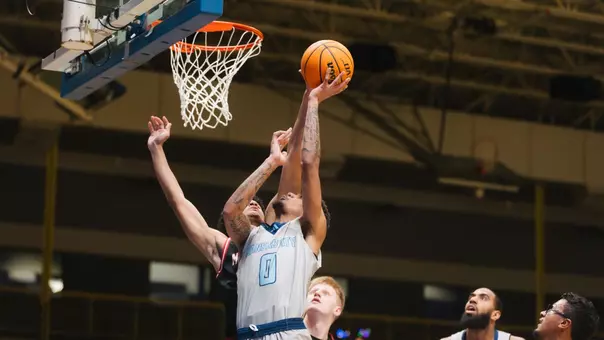 Karmello Branch takes the ball to the hoop against McPherson on Dec. 28, 2025