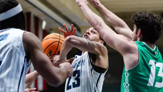 Addarin Scott battles for a rebound against North Dakota players