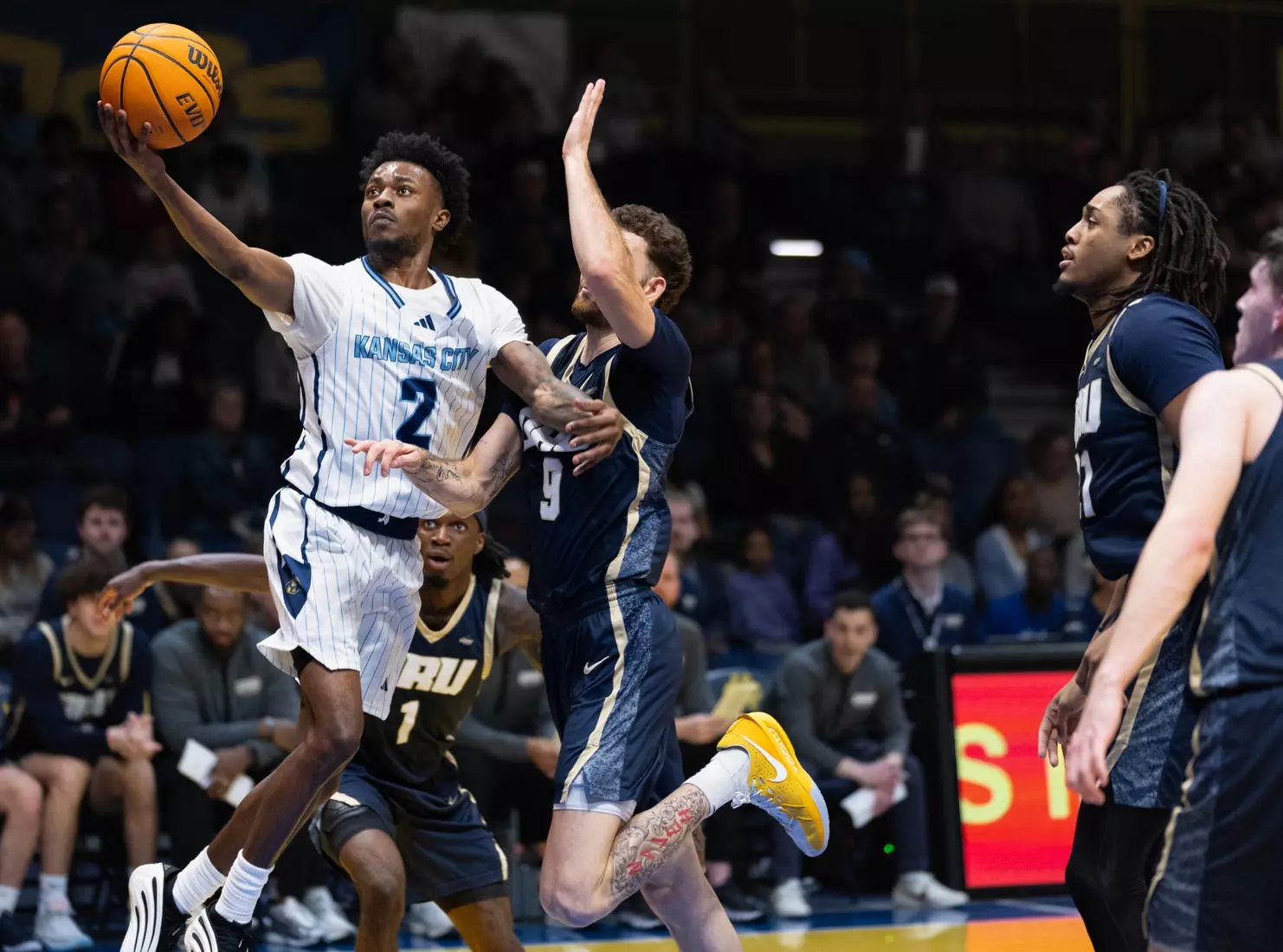 The Kansas City Roos wrapped up their home season on Senior Night in a powerful matchup against the Oral Roberts Golden Eagles, turning the arena into a celebration of resilience, pride, and Roos tradition. With a final score of 94–70 with the Golden Eagles winning, the night was about more than the scoreboard. It was about honoring the senior class for their leadership, commitment, and lasting impact on the program. From emotional pregame recognitions to high-energy plays and a packed crowd filled with family, friends, and fans. As the Roos close the chapter on their home season, their focus now shifts to postseason play as they head into the Summit League Tournament, carrying momentum, unity, and Roos pride into championship season.