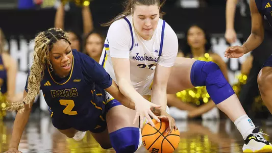 SIOUX FALLS, SD - MARCH 5: Elauni Bennett #2 of the Kansas City Roos and Brooklynn Felchle #34 of the South Dakota State Jackrabbits fight for possession of loose ball at the 2026 Summit League Basketball Championship at the Denny Sanford Premier Center in Sioux Falls, South Dakota. (Photo by Richard Carlson/Inertia)