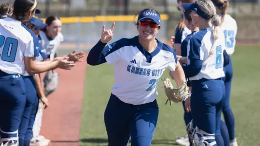 Elleana Navarro exits the pre-game lineup announcements and flashes a "Roo Up" sign to the camera